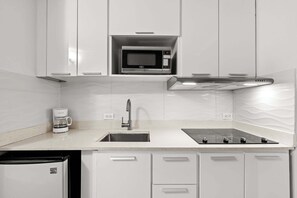 Fridge, microwave, coffee/tea maker, cookware/dishes/utensils