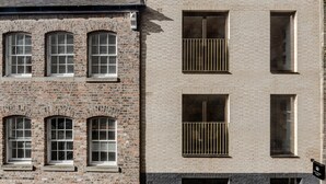 A multi-story building with a brick facade, multiple windows, and a visible entrance. - King Street Studios - King Henry IV (York)