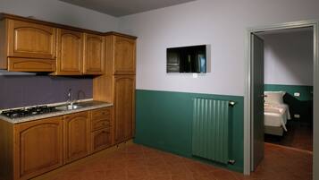 A kitchen with wooden cabinets, a stove, and a built-in microwave.