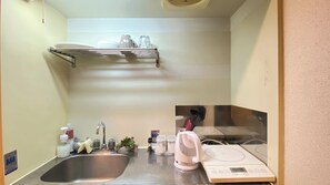 Mini-fridge, stovetop, cookware/dishes/utensils, dining tables