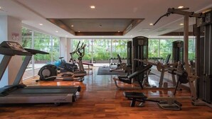 A gym with treadmills, stationary bikes, and weight machines.