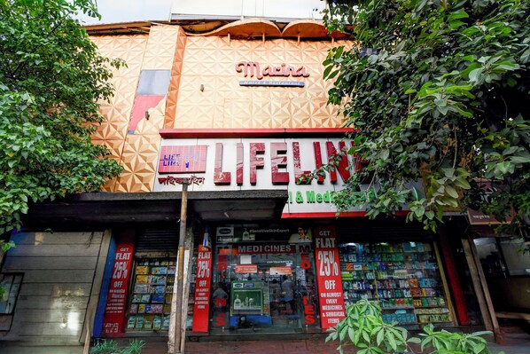 A building with a sign for 'Marina Hotel & Restaurant' and 'LIFEUN' pharmacy. - BRILL MARINA (Kolkata)