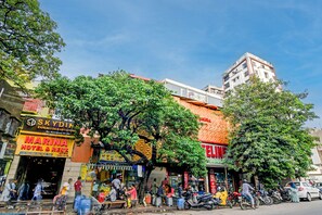 A busy street with various shops and a prominent hotel sign. - BRILL MARINA (Kolkata)