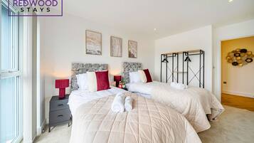 2 habitaciones, escritorio y tabla de planchar con plancha