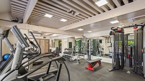 A gym with treadmills, weight machines, and free weights.