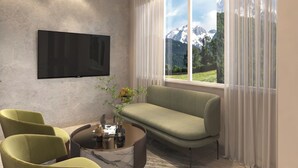 Una sala de estar moderna con un televisor de pantalla plana, un sofá, dos sillones y una mesa de centro.