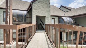 A building with a staircase leading to an entrance, a covered outdoor area, and a view of the sky. - Ski, Hike & Explore: Mtn-view Haven in Gatlinburg! (Gatlinburg)