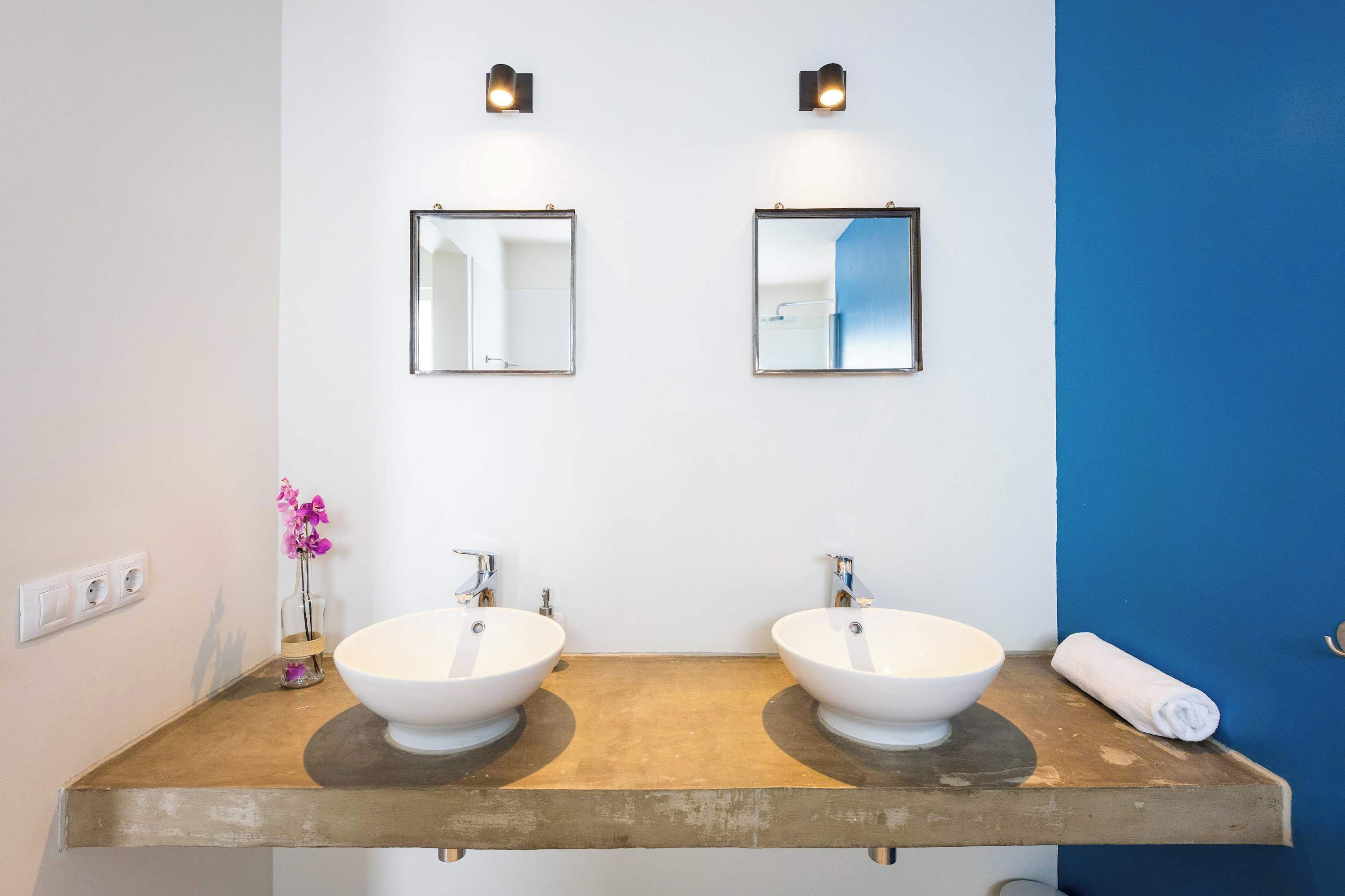 A bathroom with two sinks, a mirror, and a towel on the counter.