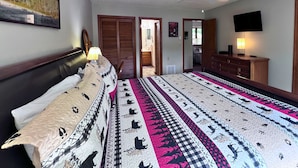 A bedroom with a bed, a ceiling fan, a TV, and a dresser. - Charming two-bedroom, two-bathroom condo minutes away from Sugar Mnt. Resort (Sugar Mountain)