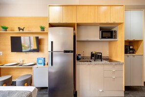 Fridge, microwave, coffee/tea maker, cookware/dishes/utensils