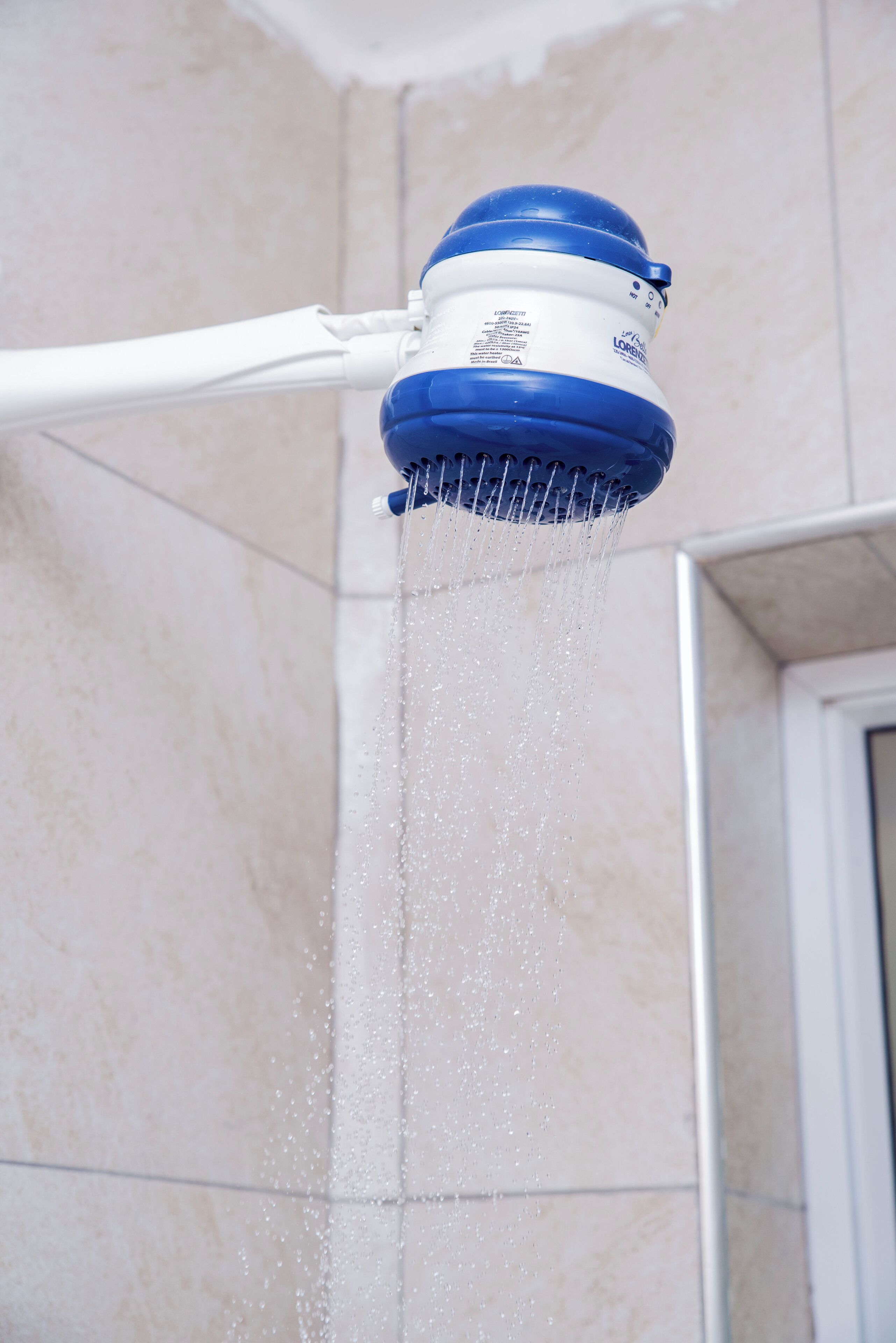 A showerhead with water flowing from it.