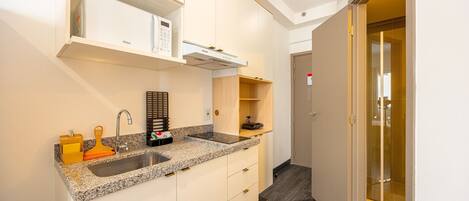 Fridge, microwave, coffee/tea maker, cookware/dishes/utensils