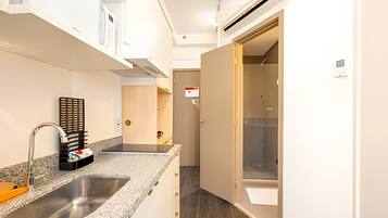 Fridge, microwave, coffee/tea maker, cookware/dishes/utensils