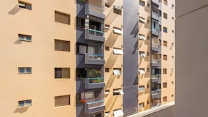 A multi-story residential building with balconies, windows, and a modern architectural design.