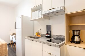Fridge, microwave, coffee/tea maker, cookware/dishes/utensils