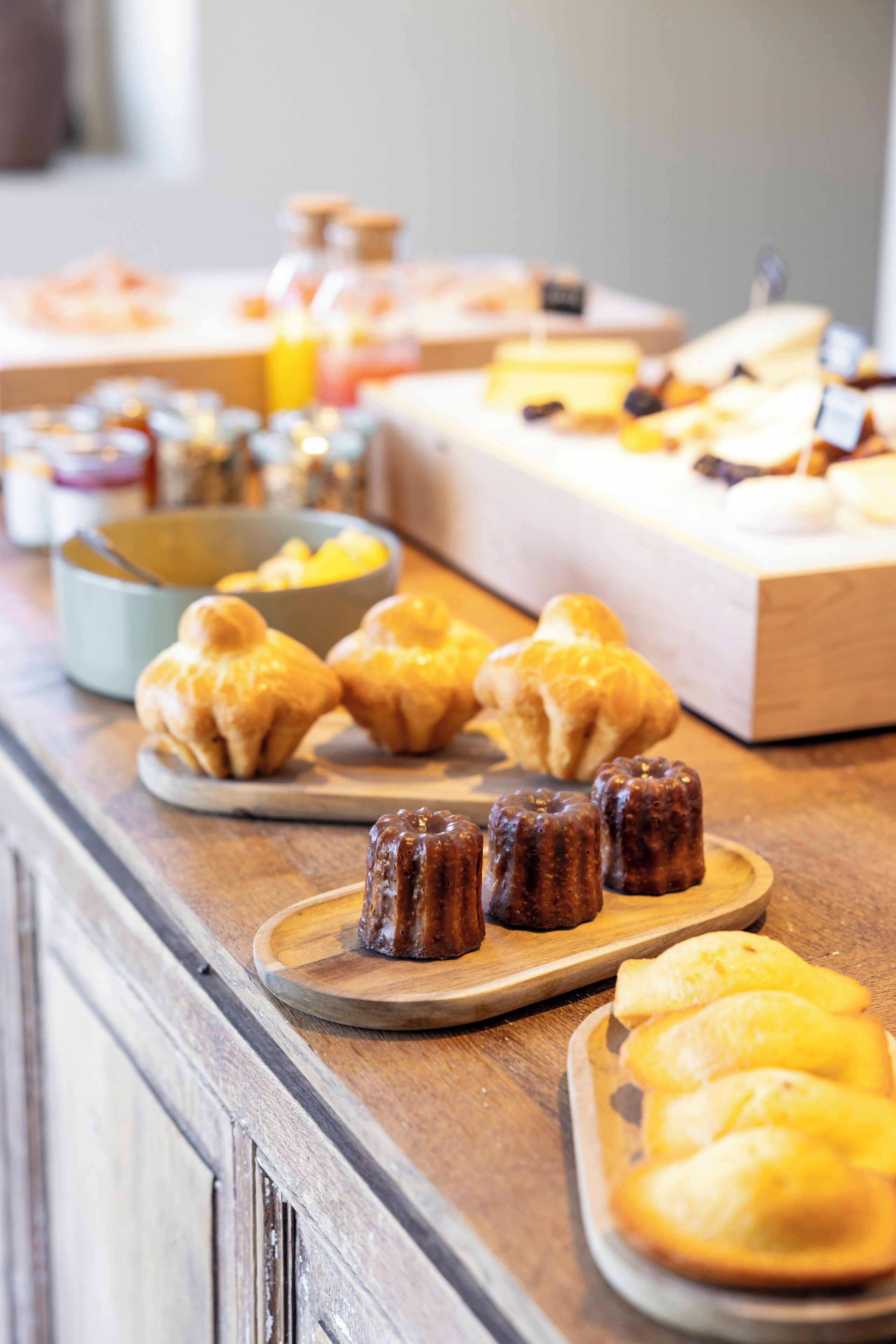 A buffet with various baked goods and pastries.