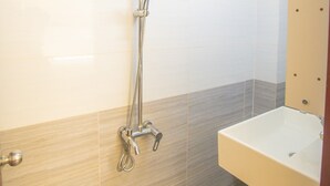 A bathroom with a shower, a sink, and a toilet. - Romantic Studio with Sunlight in the City Center (Hồ Chí Minh)