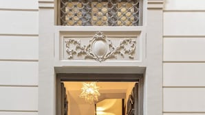 A building entrance with a staircase leading to an upper floor.