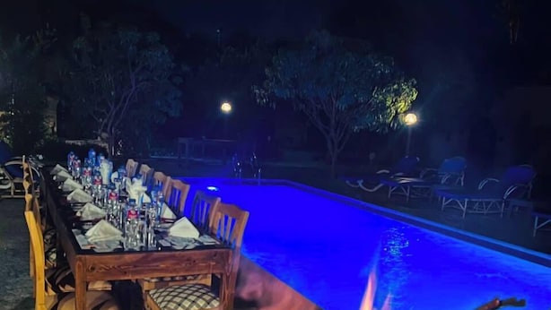 An outdoor dining area with a pool and a fire pit. - El Juneina Villas - Luxury Boutique Villas Near Valley of the Kings (Luxor)
