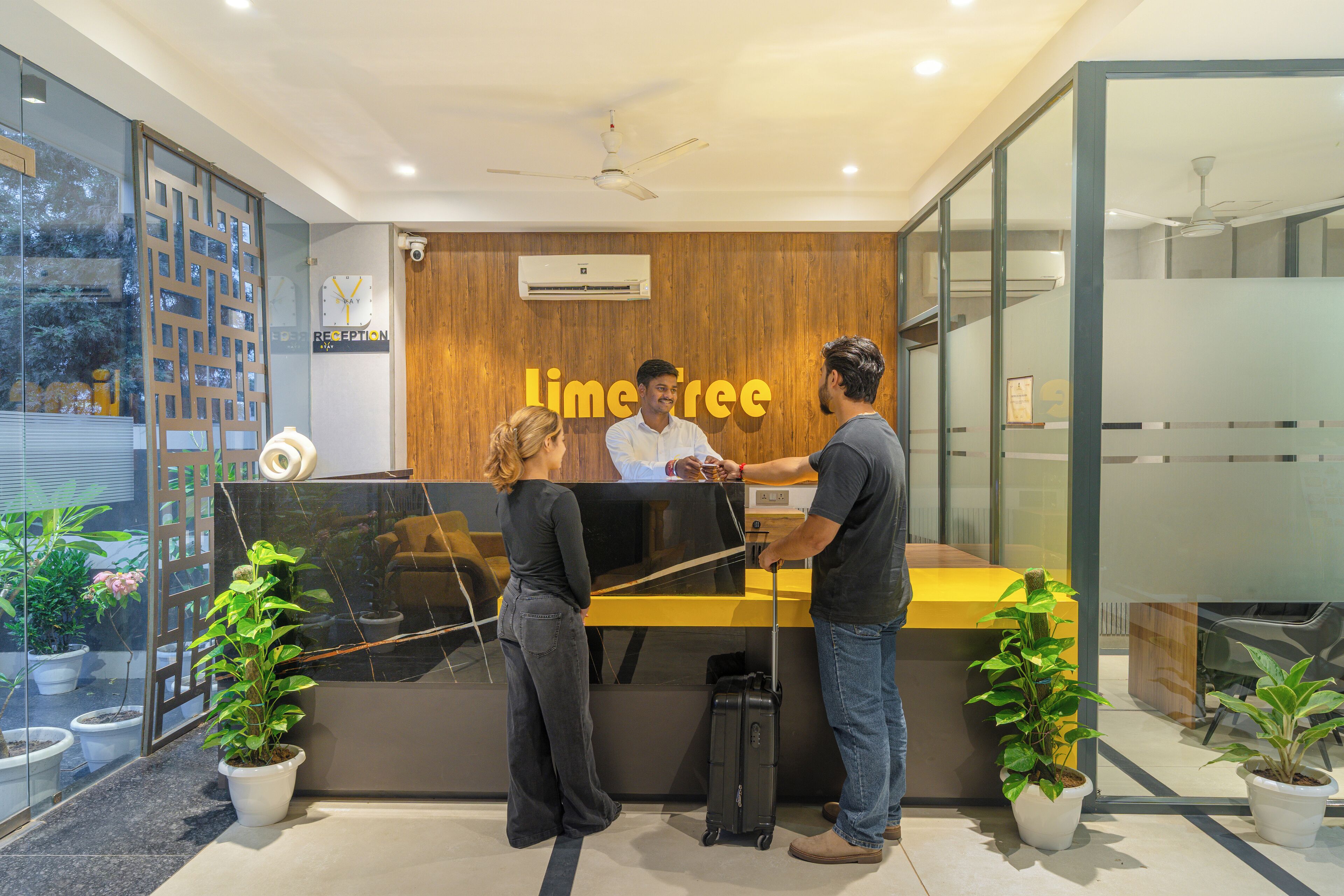 A reception desk with a wooden panel background and a sign that reads "Lime Tree."