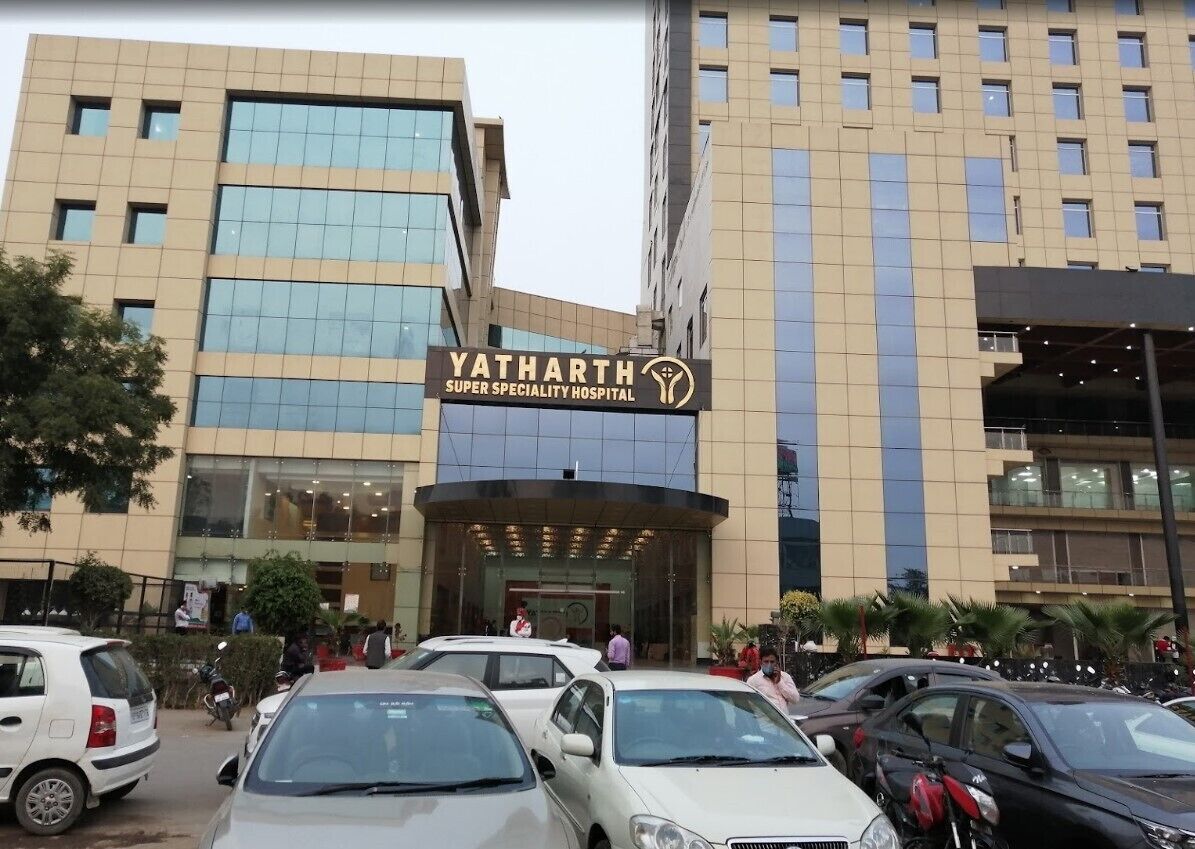 A multi-story building with a sign reading "Yatharth Super Speciality Hospital".