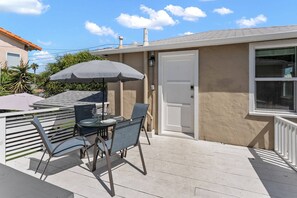 Back deck with an outdoor dining set and plenty of sun