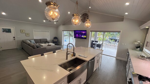 A modern kitchen with a large island, stainless steel appliances, and pendant lighting. - Waterfront, Movie Room, HotTub. 1 house, 2 Options (Tavernier)