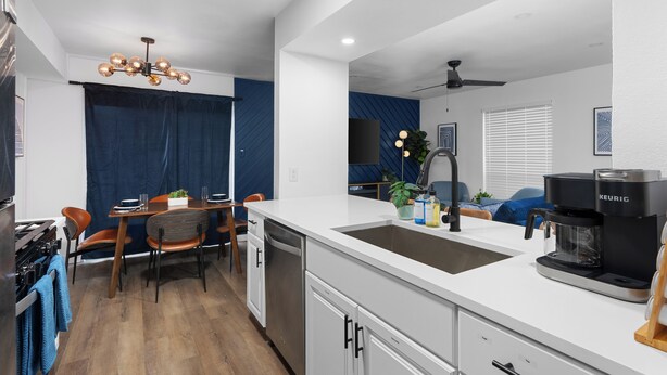 A modern kitchen with a white countertop, stainless steel appliances, and a built-in dishwasher. - Premier Access Zilker Park & SoCo (Austin)