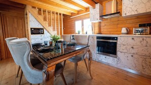 A modern kitchen with wooden beams, marble countertops, and stainless steel appliances. - KTIMA TO ALLIOTIKO - LOFOU 1 - 4 BDR VILA
LIMASSOL - CYPRUS
ENJOY FANTASTIC VAC (Lofou)