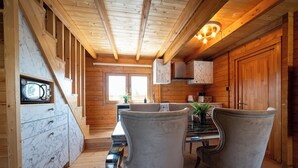 A wooden interior with a kitchen area, marble cabinets, and a dining table with chairs. - KTIMA TO ALLIOTIKO - LOFOU 1 - 4 BDR VILA
LIMASSOL - CYPRUS
ENJOY FANTASTIC VAC (Lofou)
