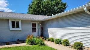 A single-story house with a front door, a small porch, and a well-maintained lawn. - Welcome!  Living rm, Family rm, 2 Bathrm w/ shower (DeForest)