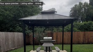 A backyard with a covered picnic table and grill area. - Micro Studio With Outdoor Space Near Nike & Intel (Beaverton)