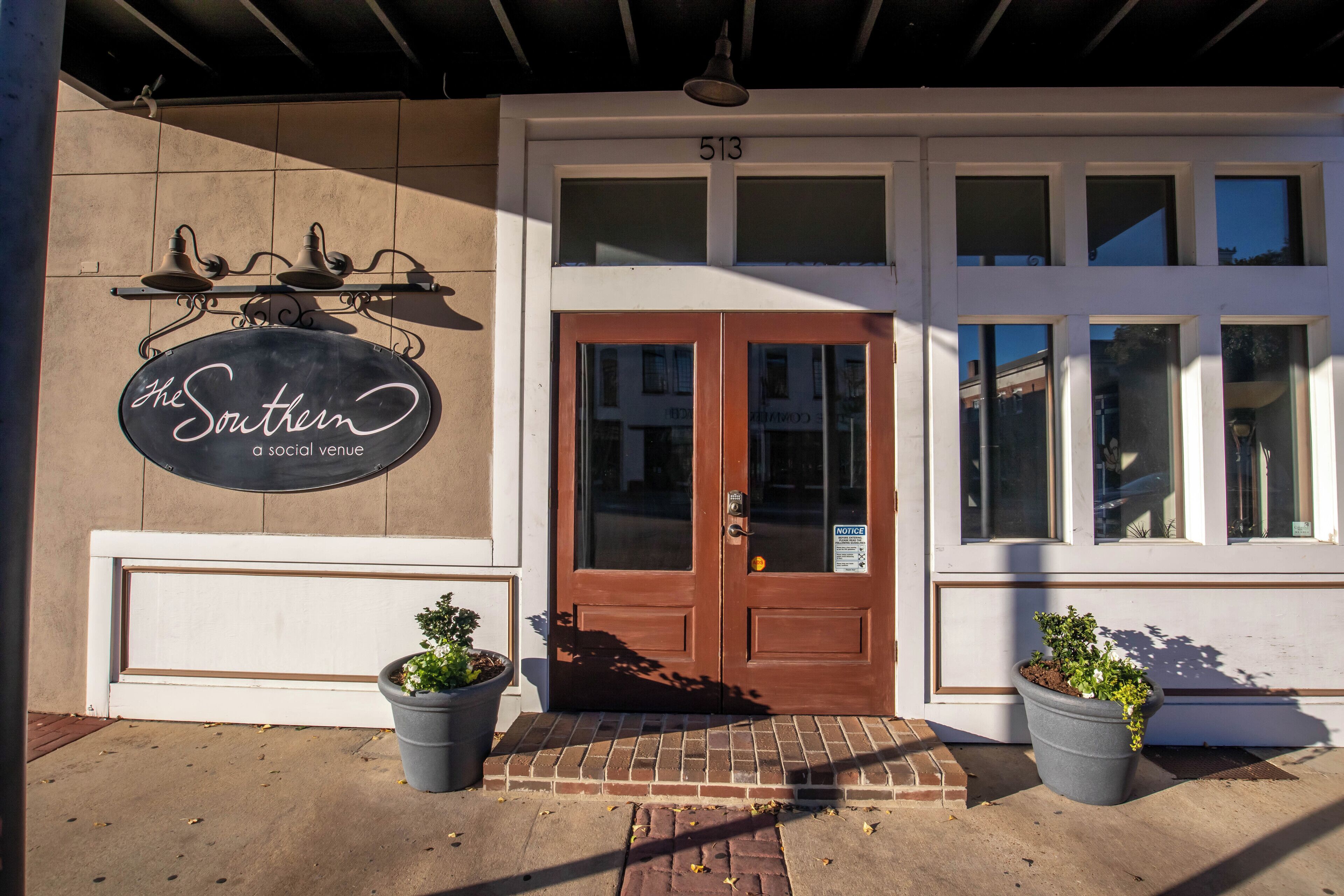 A building entrance with a sign reading 'The Southern a social venue' and a door number '513'.