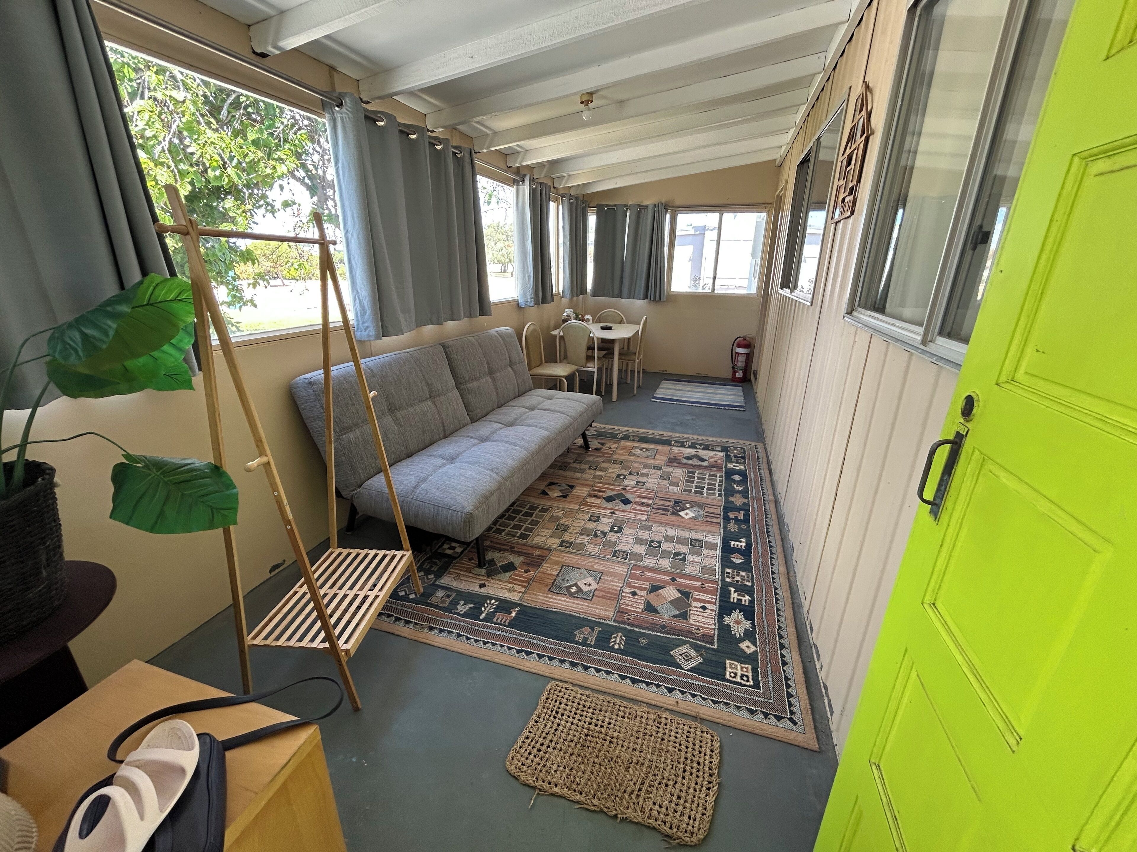 A compact room with a sofa, a small table, and a chair.