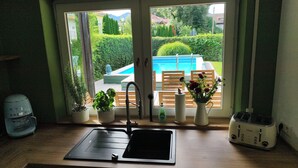 A kitchen with a sink, a toaster, and potted plants. - Vacation home Fringaluna with private pool in Übersee am Chiemsee (Übersee)