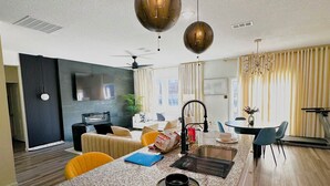 A modern kitchen with granite countertops, a built-in oven, and a central island with seating.