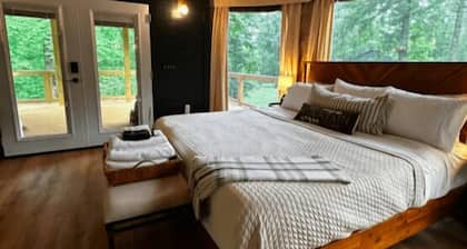 The Dogwood - Glamping tent with 1 King bed for 2 adults. En suite bathroom, kitchenette, and open porch.