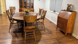 A dining room with a wooden table, chairs, and a cabinet. - Charming, newly renovated 3-bedroom house just minutes from downtown Oxford. (Oxford)