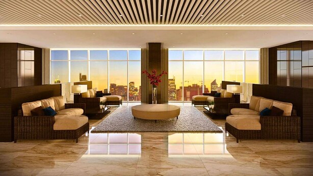 A spacious lobby with a city view, modern furnishings, and a central decorative piece. - Rent Xpress Online US Embassy (Pasay)