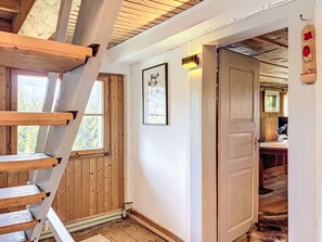 A wooden staircase leading to a loft bedroom with a skylight, a framed picture on the wall, and a door to another room. - Winterberg by Interhome (Feldberg)