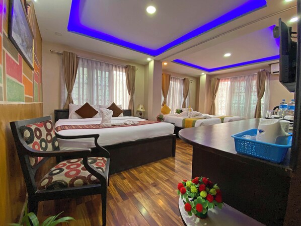 Deluxe Quadruple Room, City View | Desk, laptop workspace, free WiFi
