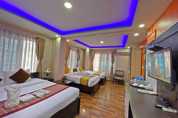 Deluxe Quadruple Room, City View | Desk, laptop workspace, free WiFi