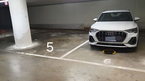 A white car parked in a parking space marked with numbers 5 and 6. - By the sea in Miramare di Rimini (Rimini)