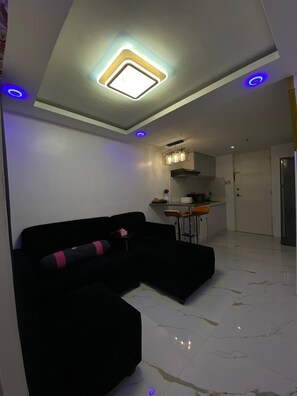 Living room - Golden Loft With Mood Lighting,stylish Staycation Loft Fast Wi-fi, Soft Couch (Pasay)