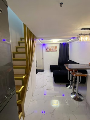 Living area - Golden Loft With Mood Lighting,stylish Staycation Loft Fast Wi-fi, Soft Couch (Pasay)