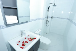 Shower, hair dryer, slippers, towels