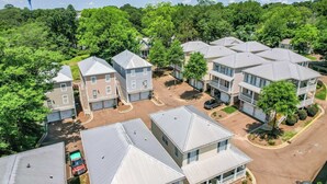 A residential area with multiple two-story houses, a central road, and a large water tower in the background. - Touchdown at Tanglewood by Apex Short Term Stays (Oxford)
