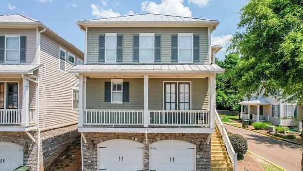 A two-story residential building with a balcony, a garage, and a brick foundation. - Touchdown at Tanglewood by Apex Short Term Stays (Oxford)