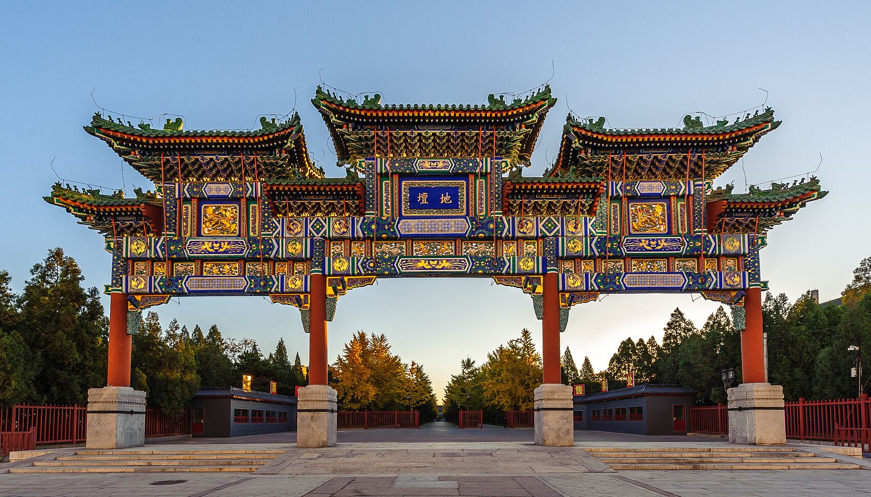 A traditional Chinese gate with intricate designs and multiple pillars.