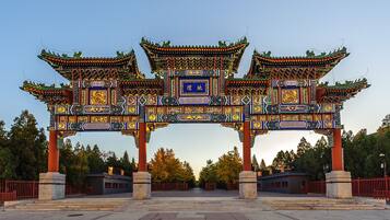 A traditional Chinese gate with intricate designs and multiple pillars.